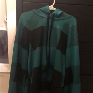 A small green and black hoodie crop top